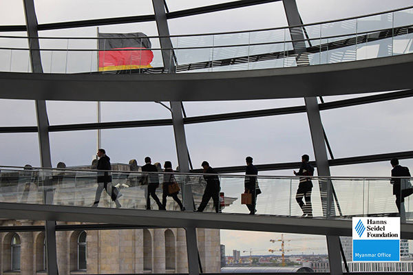 Photo inside the German Bundestag with the German Flag waving in the background 