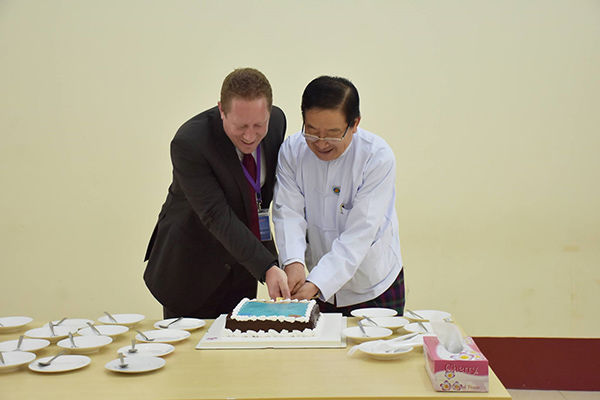 cutting the cake at the hand-over ceremony