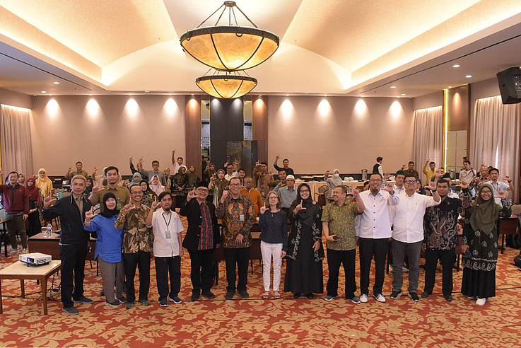 Workshop participants displaying the L greeting for “Lestari” (Sustainability in Indonesian) 