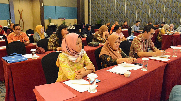 The participants listen to a presentation