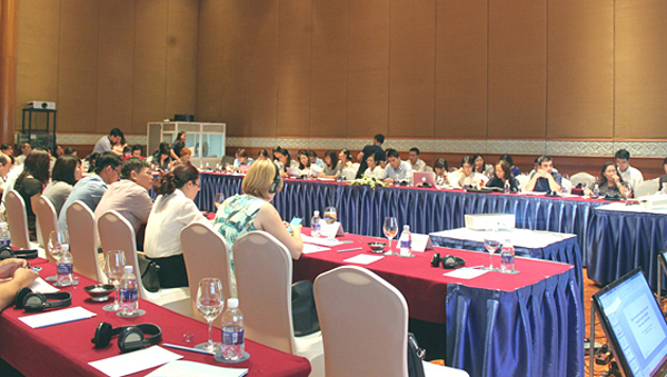 Delegates listen thoughtfully during a presentation